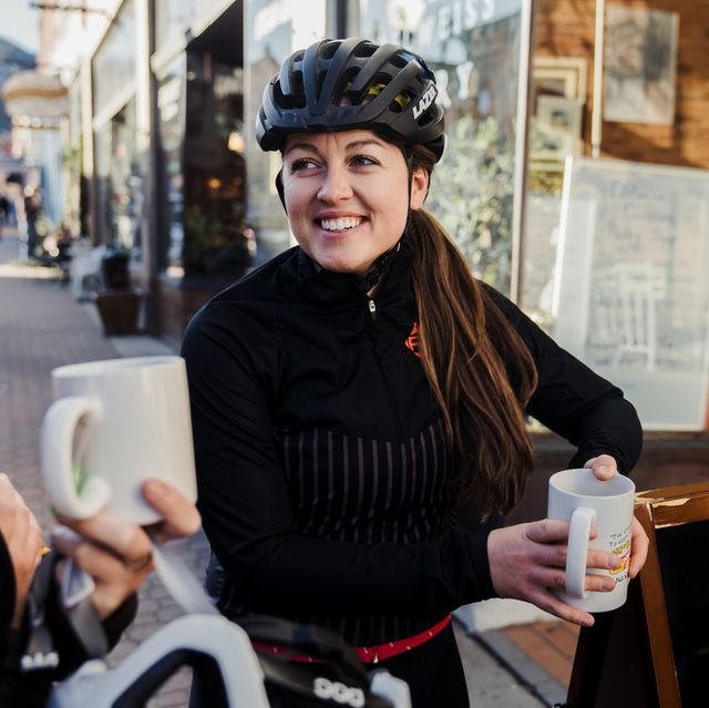 female cyclist drinking coffee