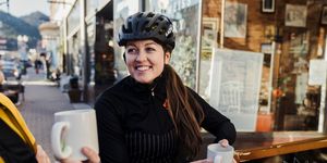 female cyclist drinking coffee
