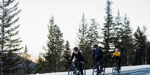 Three cyclists riding in the snow in Colorado