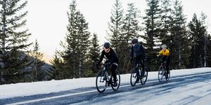 Three cyclists riding in the snow in Colorado