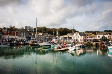 Boats Moored At Harbor Against Sky