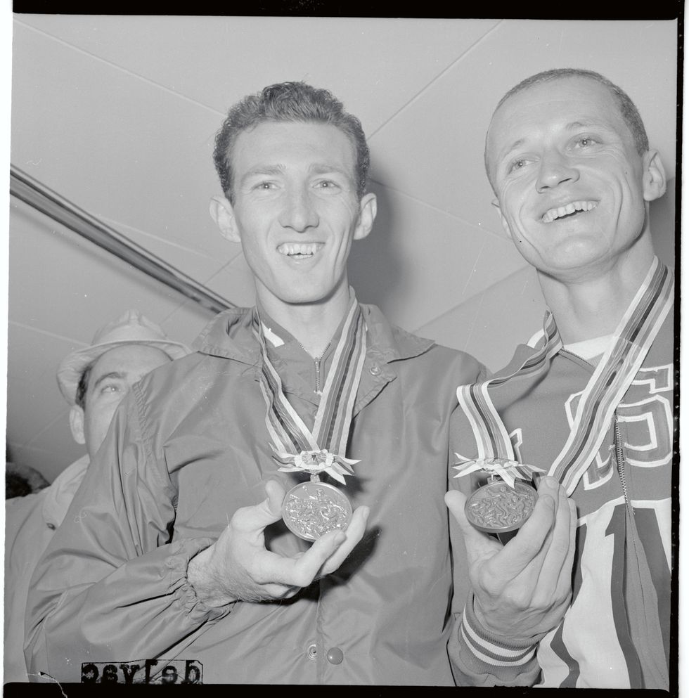 bob schul and bill dellinger posing with their medals