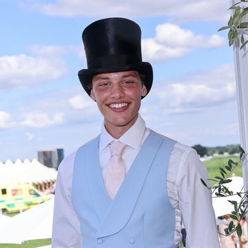 bobby brazier wears a pale blue waistcoat, pink tie and a black top hat at royal ascot racecourse