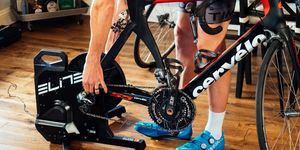 a cyclist setting up a direct drive bike trainer at home