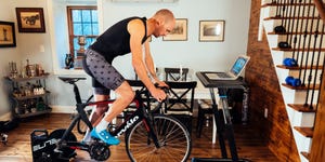 a cyclist riding an indoor trainer in a living room