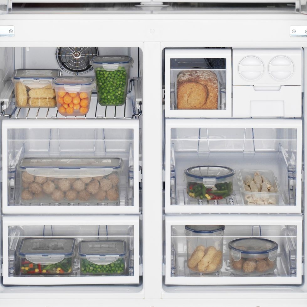 freezer neatly organizes with containers filled with food