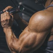 bodybuilder preparing a barbell on a power rack in gym