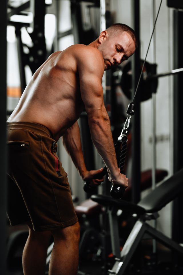bodybuilder working on triceps extension in gym
