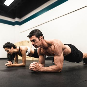 couple of fitness models on the plank position