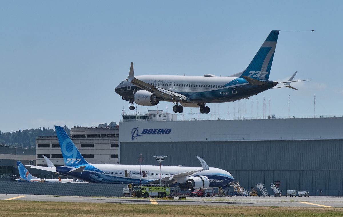 seattle, wa   june 29 a boeing 737 max aircraft lands following a faa recertification flight at boeing field on june 29, 2020 in seattle, washington the 737 max has been grounded for commercial flights since march of 2019 following two crashes in the background is a boeing 777x test plane photo by stephen brasheargetty images