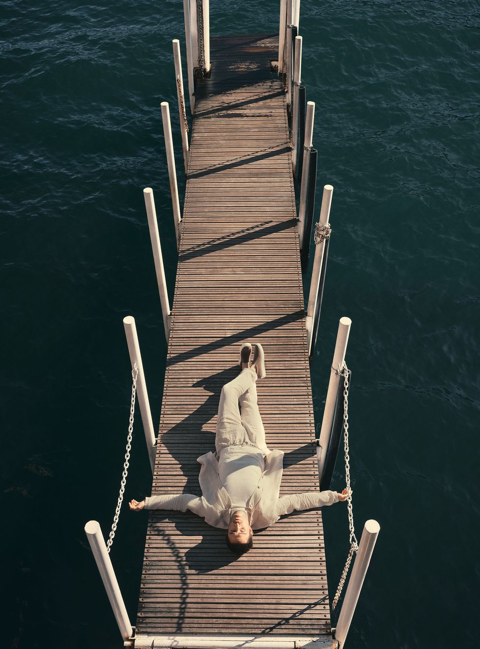 ed lying down on a dock