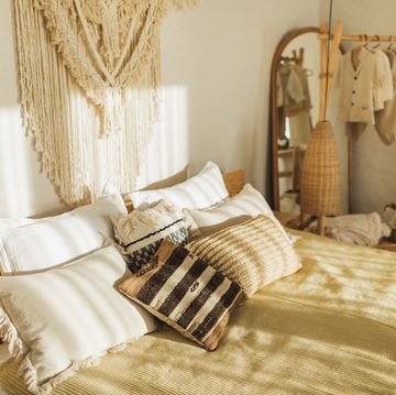 boho pillows on bed in bedroom.