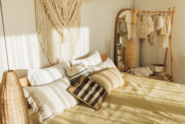 boho pillows on bed in bedroom.