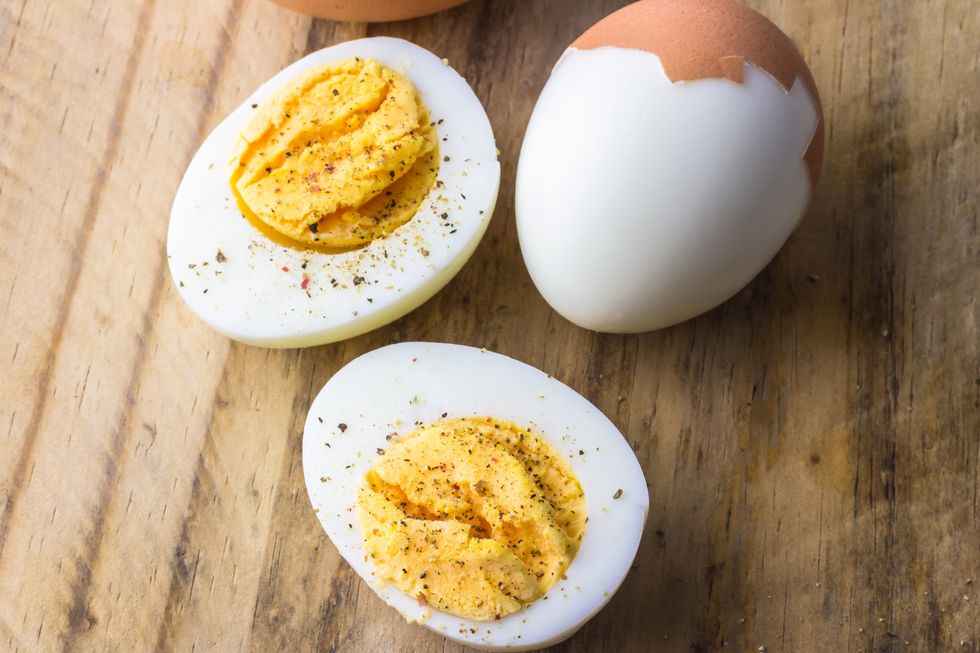 boiled eggs on wooden board with pepper flakes