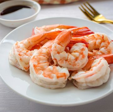 boiled shrimp in white ceramic plate on white background