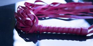 Bondage leather s&m whip for adult kinky domination sex games.