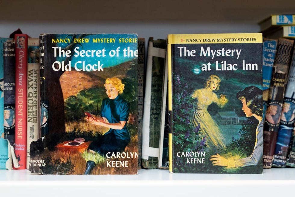 nancy drew book's the secret of the old clock and the mystery at lilac inn sitting on a library shelf