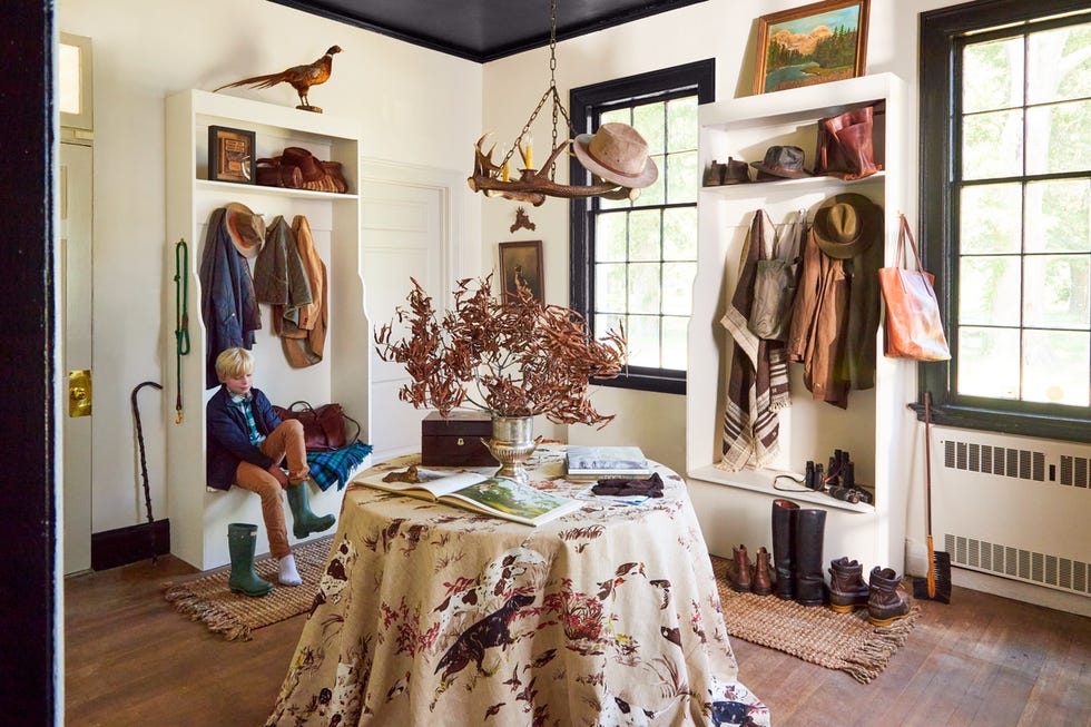english style boot room with builtin cubbies and skirted table