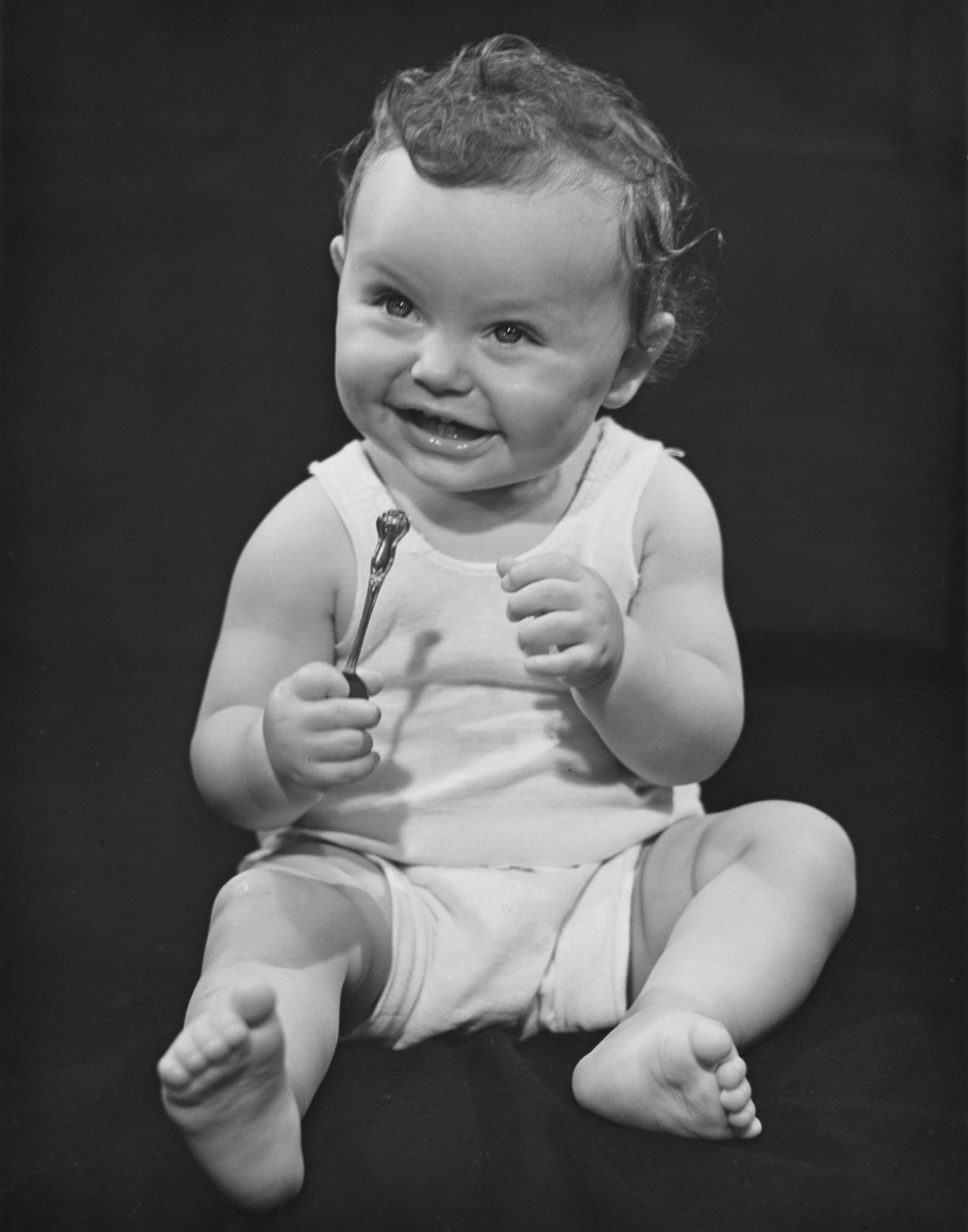 1940s 1950s creative smiling African-American boy toddler sitting