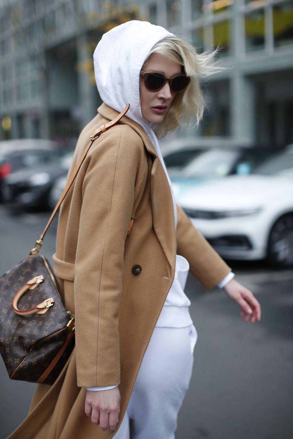 berlin, germany   december 11 german model and actress victoria jancke wearing a white hoodie by asos, white pants by asos, white socks by wrangler, a camel colored long coat by vero moda, a light and dark brown speedy 30 monogram canvas bag by louis vuitton and brown bamboo "u2018goldie"u2019 sunglasses by truespinduring a street style shooting on december 11, 2020 in berlin, germany photo by streetstyleshootersgetty images