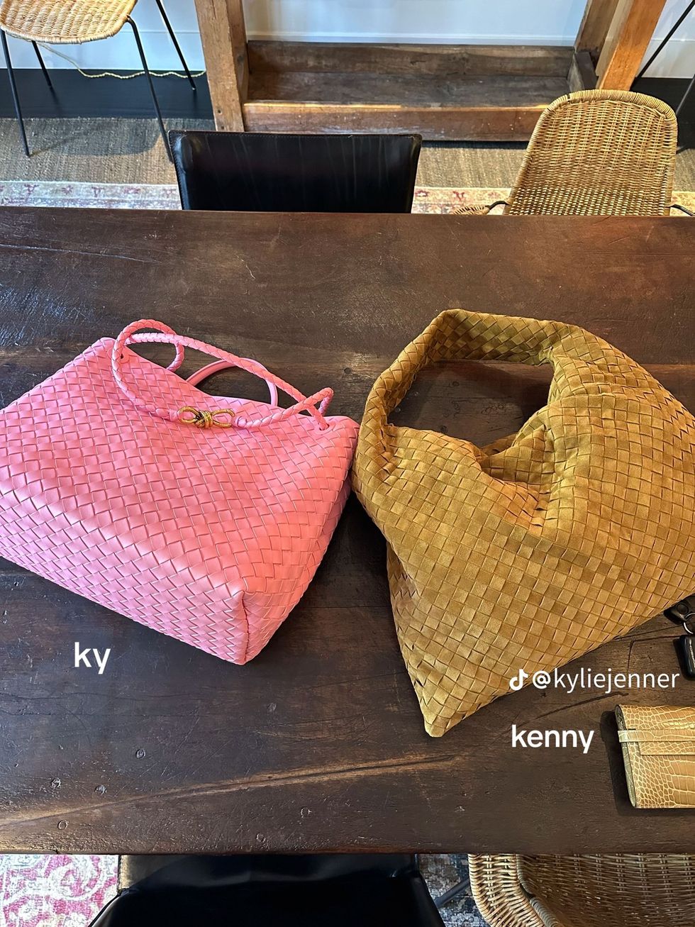 a pair of pink and white purses on a table