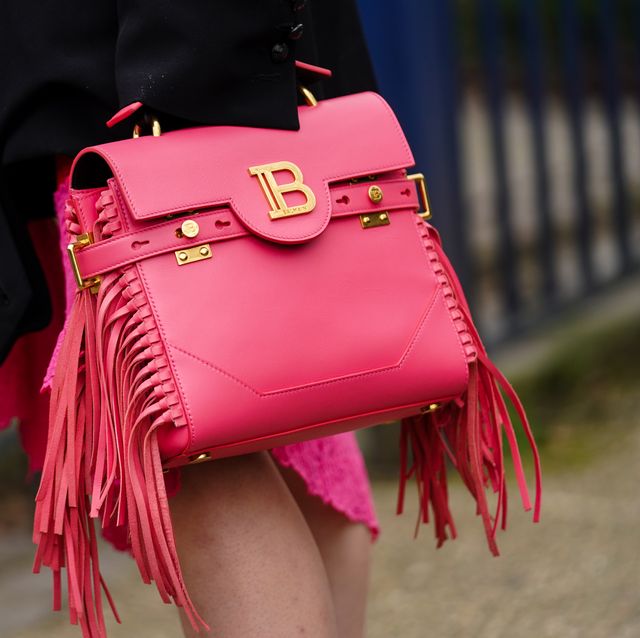 paris, france   february 28 a guest wears a red leather balmain bag with fringes, outside balmain, during paris fashion week   womenswear fallwinter 20202021, on february 28, 2020 in paris, france photo by edward berthelotgetty images