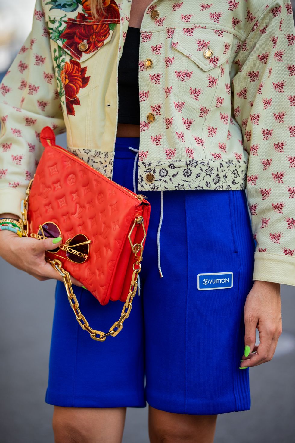 berlin, germany   june 15 sonia lyson is seen wearing total look louis vuitton, red bag, blue shorts, jacket with floral print, sandals with logo print and cropped black top on june 15, 2021 in berlin, germany photo by christian vieriggetty images