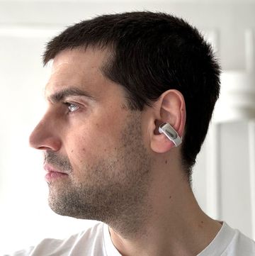 profile of man wearing bose open ear headphones