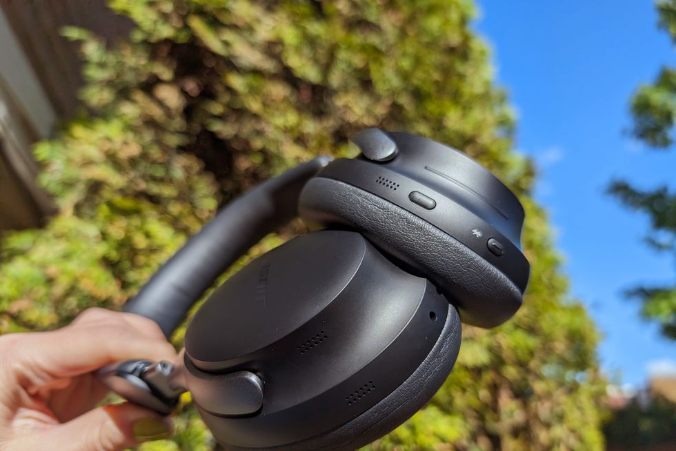 bose quietcomfort ultra headphones held up against blue sky