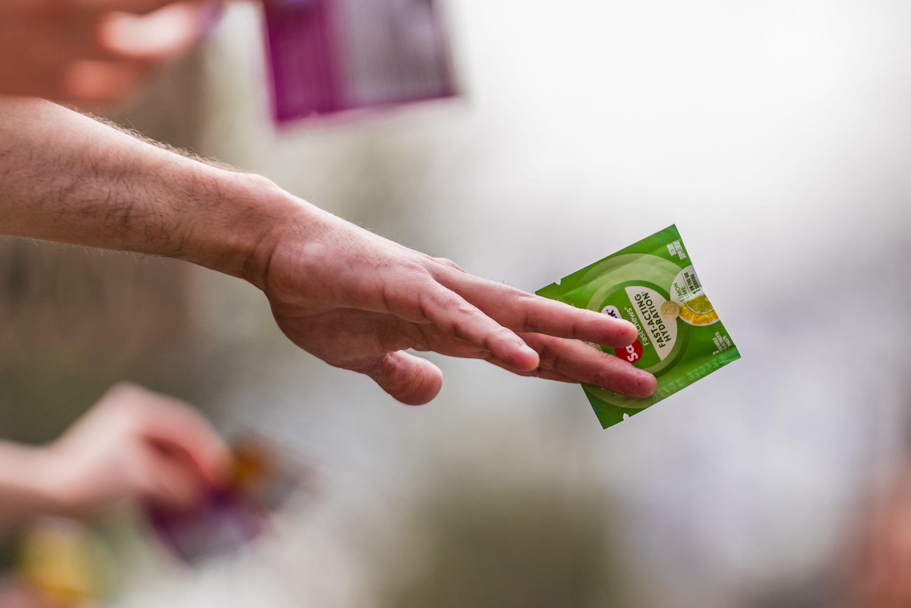 a person holds out a package of electrolytes