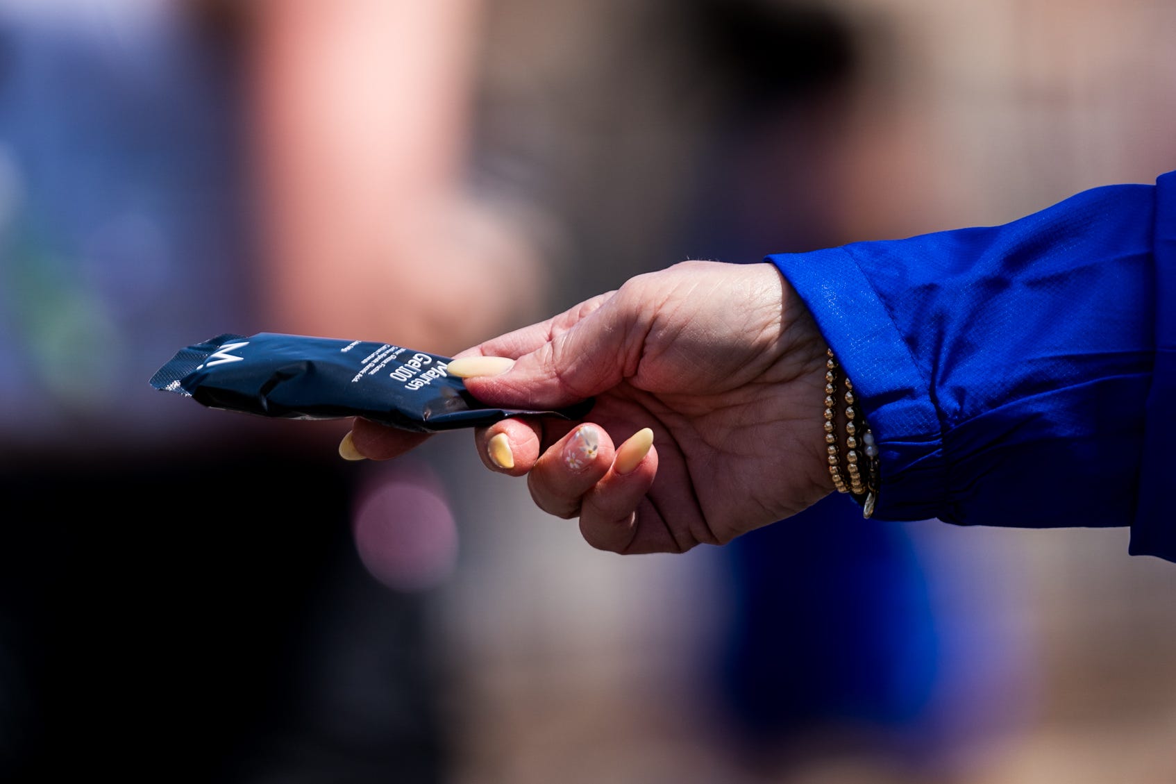 a person holding out an energy gel