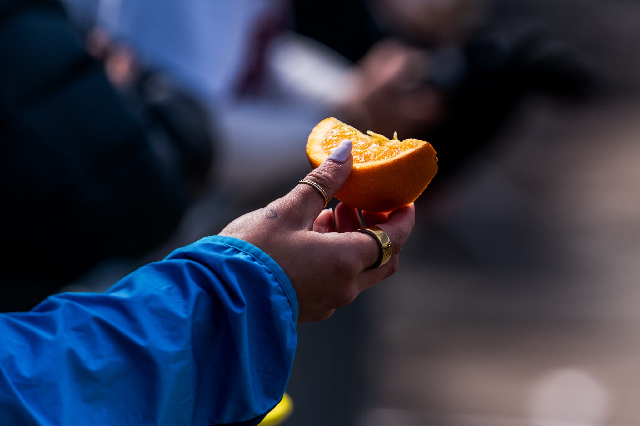 a person holds out an orange slice