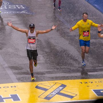 a group of runners celebrate at the boston marathon finish line