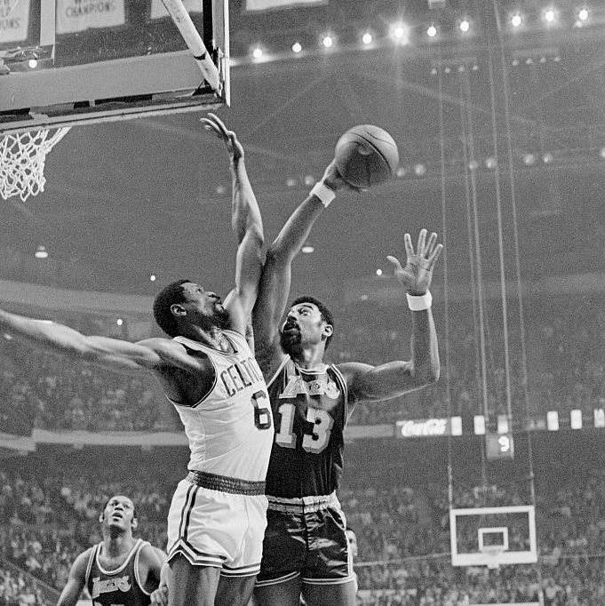 wilt chamberlain trys for basket as bill russell defends