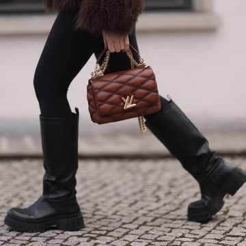 a person wearing a leather jacket and boots