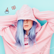 best hair color removers   image of a girl with purple hair covering her face with a pink sweatshirt