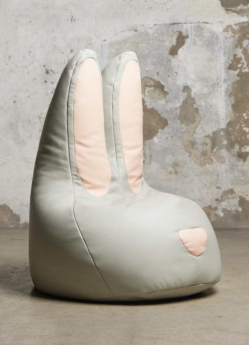 a soft rabbitshaped bean bag chair with large ears and a subtle color palette