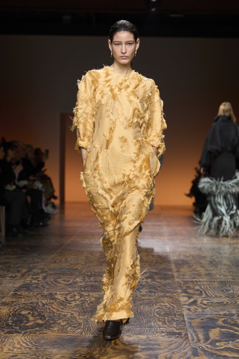 a person wearing a gold dress