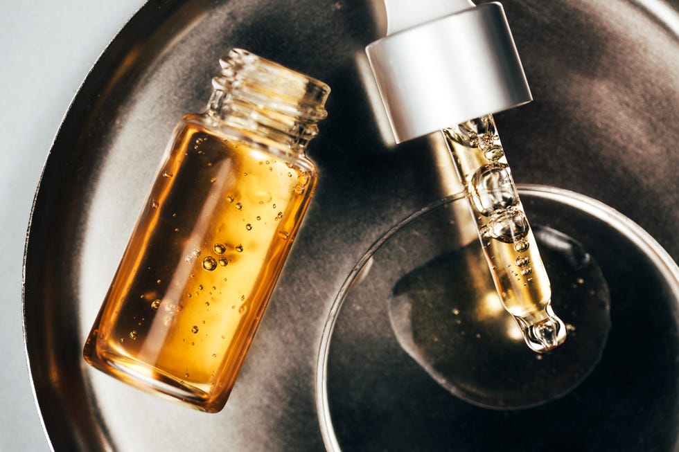 bottle and pipette with aromatic oil on plate