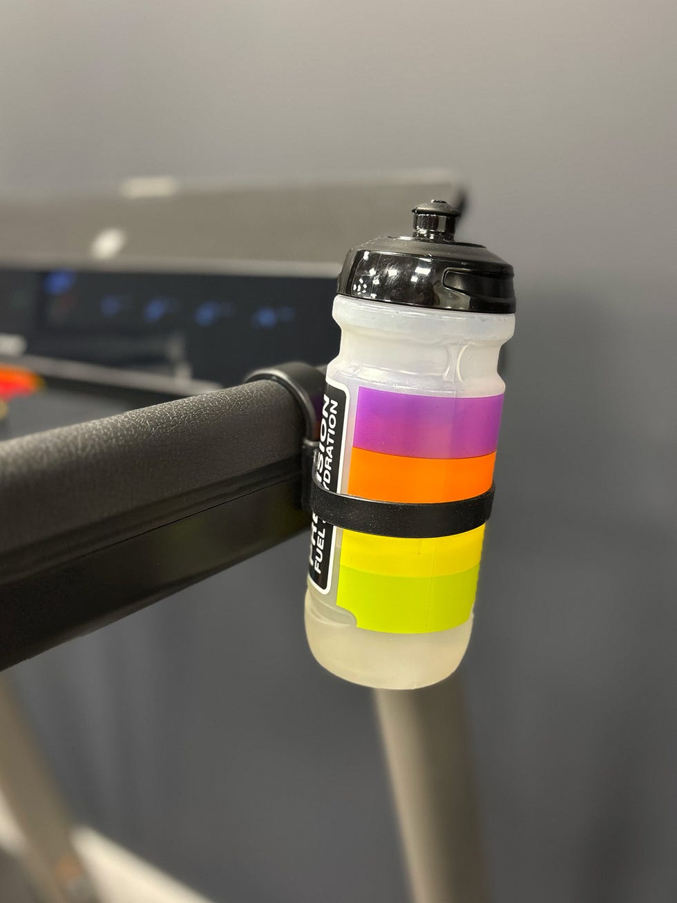 water bottle attached to the arm of a treadmill