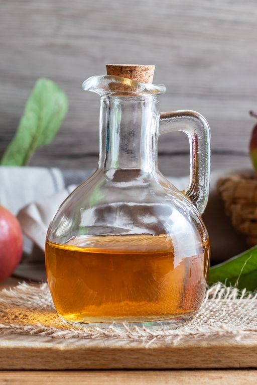 A Bottle Of Apple Cider Vinegar With Fresh Apples
