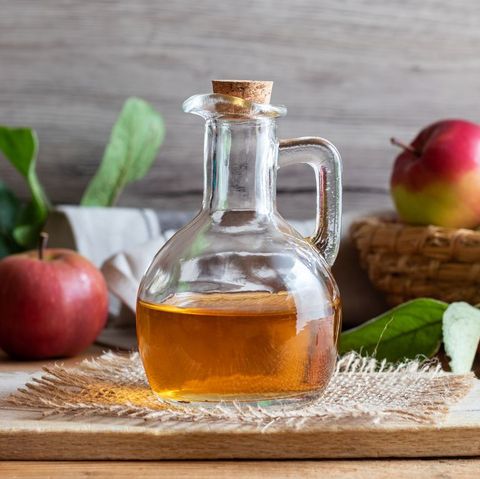 A Bottle Of Apple Cider Vinegar With Fresh Apples