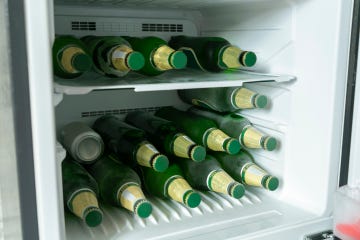 bottles full of beer in a refrigerator