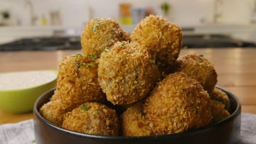 fried boudin balls in a black bowl
