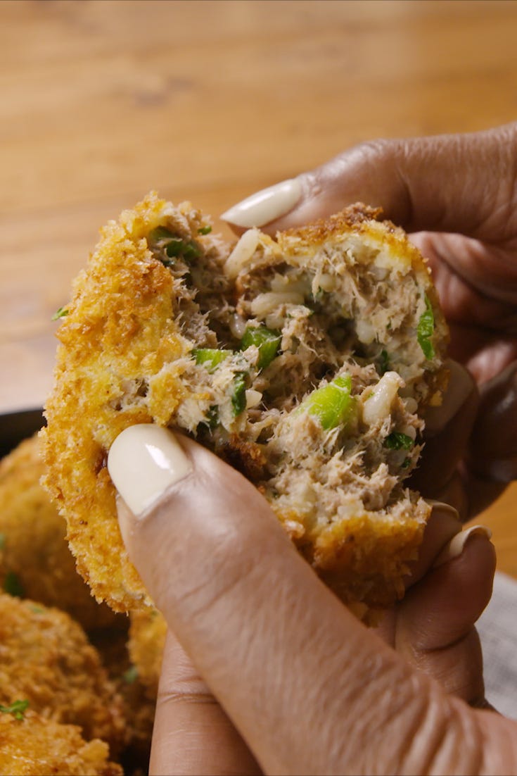 a hand with white nails tearing open a boudin ball