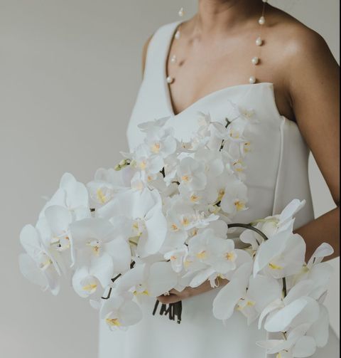 White, Clothing, Dress, Bouquet, Flower, Wedding dress, Gown, Shoulder, Arm, Petal, 