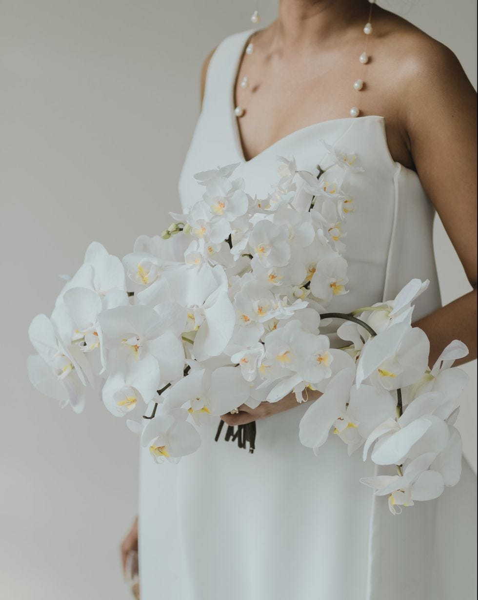 White, Clothing, Dress, Bouquet, Flower, Wedding dress, Gown, Shoulder, Arm, Petal, 