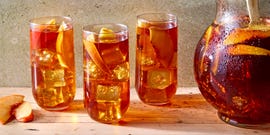 peach iced tea in a glass with bourbon