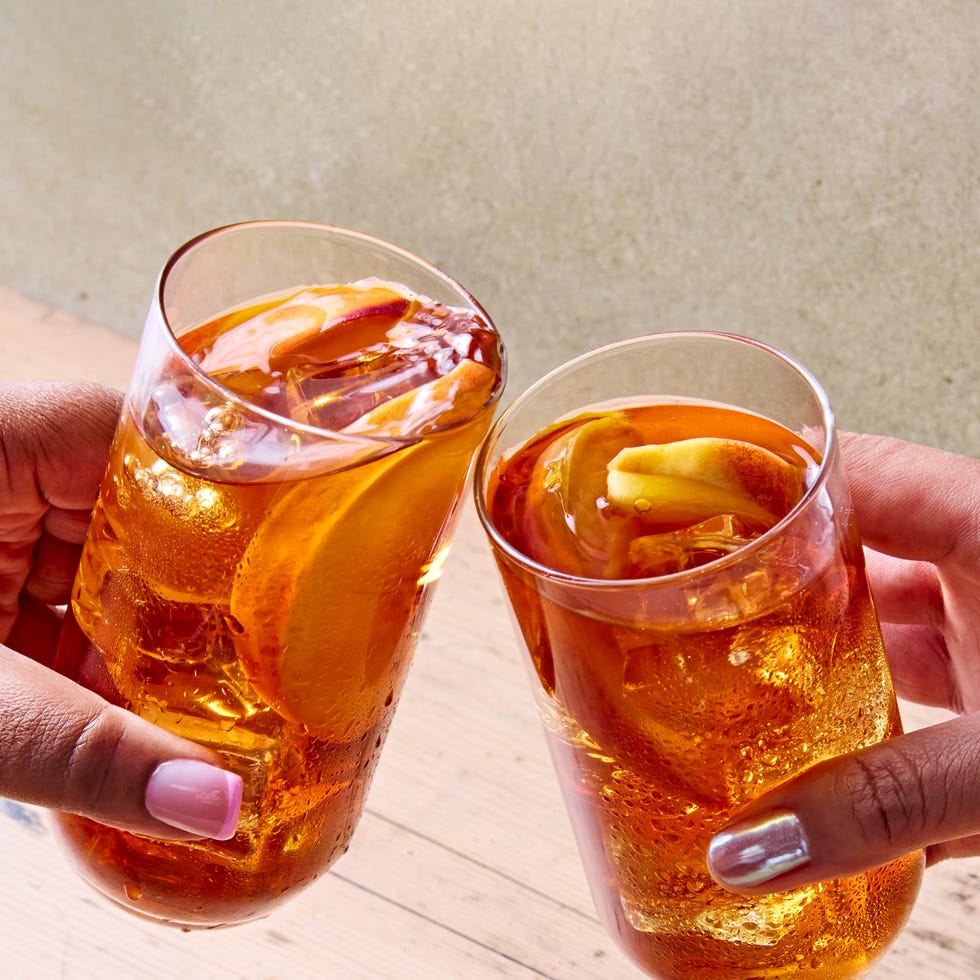 peach iced tea in a glass with bourbon