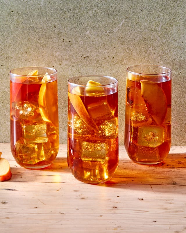 peach iced tea in a glass with bourbon
